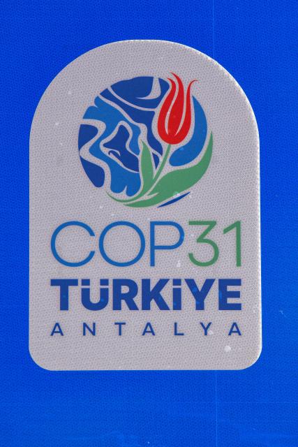 This photograph shows a logo of "COP31 Antalya" next to the entrance of Antalya Expo venue in Antalya on September 30, 2026, where the 2026 United Nations Climate Change Conference (COP31) will be held in Antalya. Turkey will host the COP31 climate talks from November 9 till 20 in the Mediterranean resort of Antalya. (Photo by Goksel YAPAR / AFP)