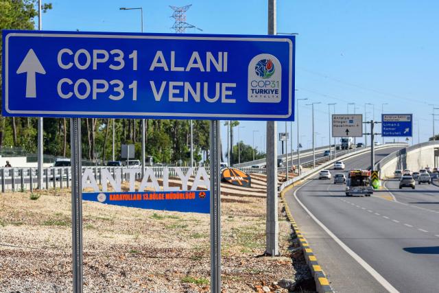 This photograph shows a traffic direction sign reading "COP31 venue" near the entrance Antalya Expo venue in Antalya on September 30, 2026, where the 2026 United Nations Climate Change Conference (COP31) will be held in Antalya. Turkey will host the COP31 climate talks from November 9 till 20 in the Mediterranean resort of Antalya. (Photo by Goksel YAPAR / AFP)
