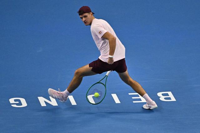 Czech Republic's Jakub Mensik hits a return to Kazakhstan's Alexander Bublik during their men's singles match at the China Open tennis tournament in Beijing on October 1, 2026. (Photo by Pedro PARDO / AFP)