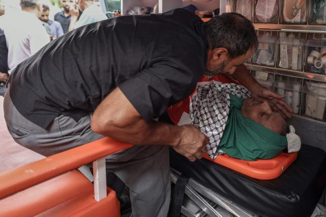 EDITORS NOTE: Graphic content / A relative of Palestinian Mashhour Yassin, 51, mourns over his body at the Salfit Hospital in Salfit in the Israeli-occupied West Bank on October 1, 2026, after he was shot dead by Israeli settlers during a raid on the village of Yasuf southwest of Nablus, according to the mayor and the Palestinian health ministry. The raid came as international criticism mounts over surging levels of settler violence against Palestinians in the territory, which Israeli Prime Minister Benjamin Netanyahu downplayed last week. Israel's military told AFP it was looking into the details of the attack. (Photo by JAAFAR ASHTIYEH / AFP)