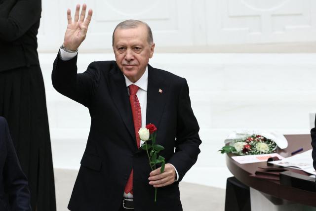 Turkish President Recep Tayyip Erdogan waves towards Turkish members of parliament after delivering a speech during the opening of the parliamentary session at the Grand National Assembly of Turkey (TBMM) in Ankara, on October 1, 2026. (Photo by Adem ALTAN / AFP)