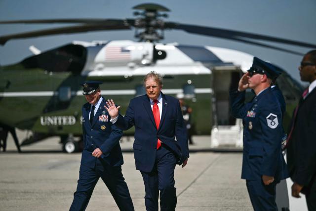 US President Donald Trump waves as he walks to boards Air Force One at Joint Base Andrews, Maryland on October 1, 2026. Trump is travelling to Texas and Oklahoma to speak at campaign rallies. (Photo by Kent NISHIMURA / AFP)