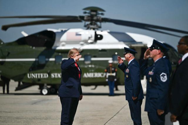 US President Donald Trump salutes as he walks to boards Air Force One at Joint Base Andrews, Maryland on October 1, 2026. Trump is travelling to Texas and Oklahoma to speak at campaign rallies. (Photo by Kent NISHIMURA / AFP)