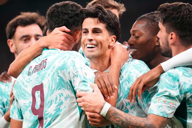 Portugal's defender #20 Joao Cancelo (C) celebrates scoring the opening goal with his teammates during the UEFA Nations League Group A4 match between Denmark and Portugal at Parken stadium in Copenhagen on October 1, 2026. (Photo by Liselotte Sabroe / Ritzau Scanpix / AFP) / Denmark OUT