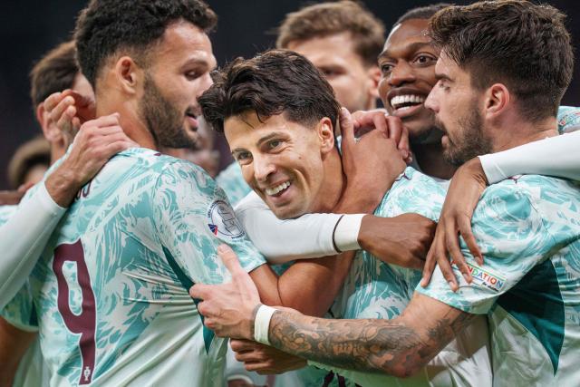 Portugal's defender #20 Joao Cancelo (C) celebrates scoring the opening goal with his teammates during the UEFA Nations League Group A4 match between Denmark and Portugal at Parken stadium in Copenhagen on October 1, 2026. (Photo by Liselotte Sabroe / Ritzau Scanpix / AFP) / Denmark OUT