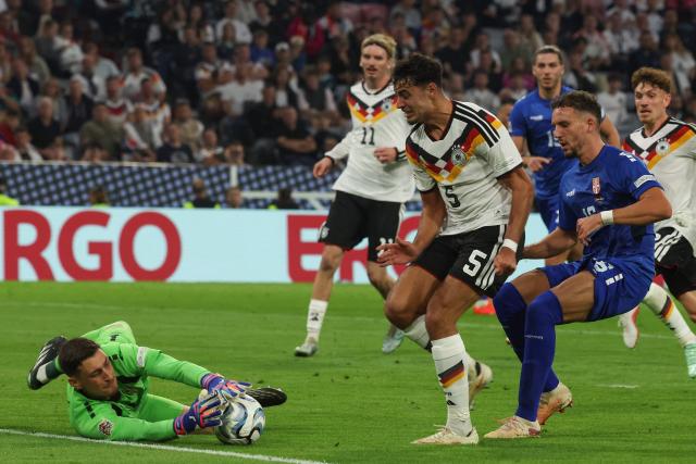 Serbia's goalkeeper #01 Djordje Petrovic (L) prevents Germany's midfielder #05 Aleksandar Pavlovic from scoring during the UEFA Nations League Group A2 between Germany and Serbia at the Allianz Arena in Munich, southern Germany on October 1, 2026. (Photo by Karl-Josef HILDENBRAND / AFP)