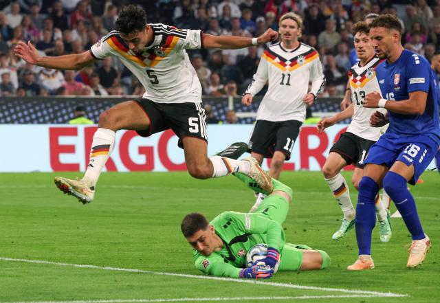 Serbia's goalkeeper #01 Djordje Petrovic prevents Germany's midfielder #05 Aleksandar Pavlovic (L) from scoring during the UEFA Nations League Group A2 between Germany and Serbia at the Allianz Arena in Munich, southern Germany on October 1, 2026. (Photo by Karl-Josef HILDENBRAND / AFP)