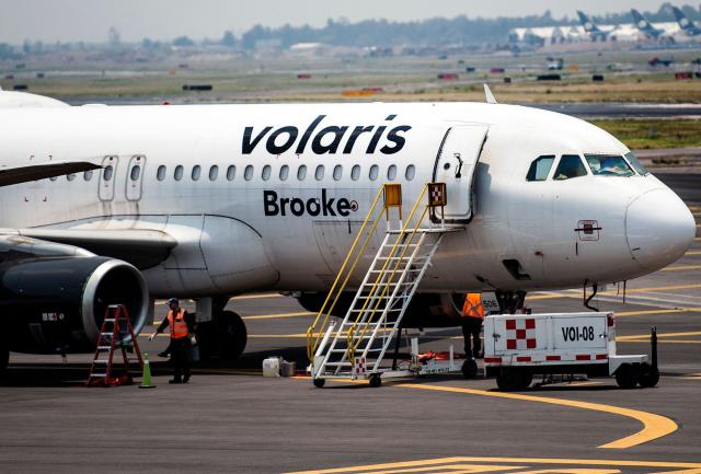 (FILES) A Volaris airline plane sits on the tarmac at the Benito Juarez International airport, in Mexico City, on May 20, 2020, amid the new Covid-19 coronavirus pandemic. Mexican airlines Aeromexico and Volaris announced on October 1st, 2026 the suspension of their flights to Tulum International Airport, one of the most popular destinations in the Mexican Caribbean, citing rising costs and low occupancy on the planes that cover the route. (Photo by PEDRO PARDO / AFP)