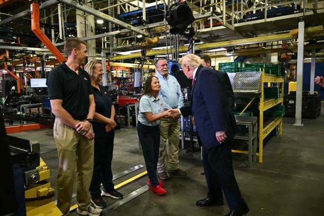 US President Donald Trump greets workers at the Peterbilt Motors facility in Denton, Texas, on October 1, 2026. (Photo by Kent NISHIMURA / AFP)