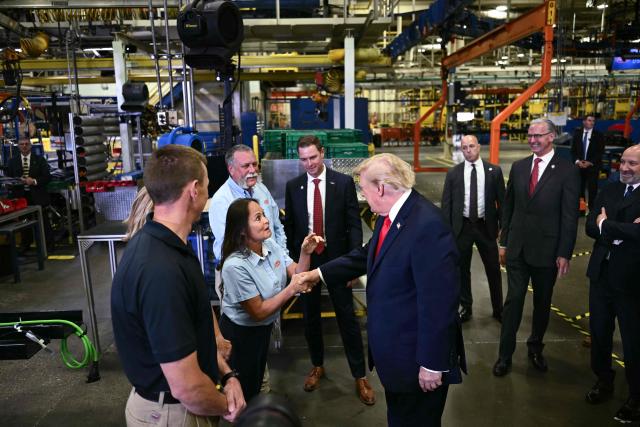 US President Donald Trump greets workers at the Peterbilt Motors facility in Denton, Texas, on October 1, 2026. (Photo by Kent NISHIMURA / AFP)