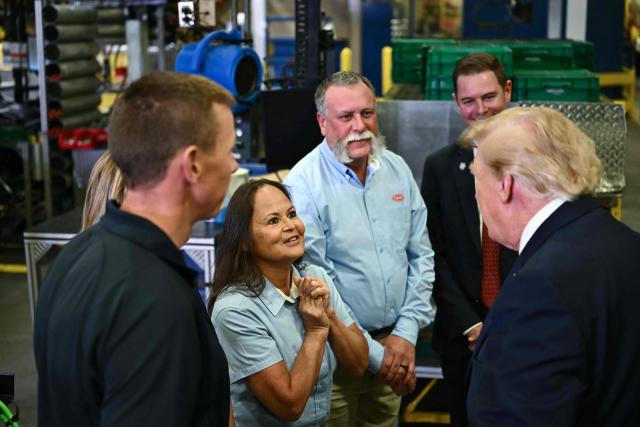US President Donald Trump greets workers at the Peterbilt Motors facility in Denton, Texas, on October 1, 2026. (Photo by Kent NISHIMURA / AFP)