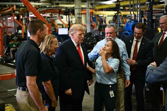US President Donald Trump speaks with employees as he tours the Peterbilt Motors facility in Denton, Texas, on October 1, 2026. (Photo by Kent NISHIMURA / AFP)