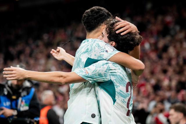 Portugal's midfielder #23 Vitinha (R) celebrates after scoring Portugal's third goal during the UEFA Nations League Group A4 match between Denmark and Portugal at Parken stadium in Copenhagen on October 1, 2026. (Photo by Sebastian Elias Uth / Ritzau Scanpix / AFP) / Denmark OUT