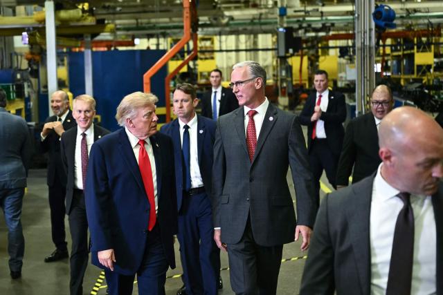 US President Donald Trump tours the Peterbilt Motors facility with the CEO of Paccar, Petebuilt's parent company, Preston Feight, in Denton, Texas, on October 1, 2026. (Photo by Kent NISHIMURA / AFP)