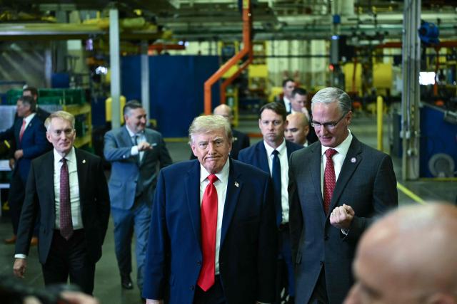 US President Donald Trump tours the Peterbilt Motors facility with the CEO of Paccar, Petebuilt's parent company, Preston Feight, in Denton, Texas, on October 1, 2026. (Photo by Kent NISHIMURA / AFP)