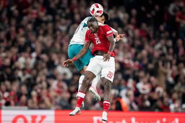 Portugal's defender #20 Joao Cancelo (L) and Denmark's forward #20 Mohamed Daramy (R) fight for the ball in the air during the UEFA Nations League Group A4 match between Denmark and Portugal at Parken stadium in Copenhagen on October 1, 2026. (Photo by Sebastian Elias Uth / Ritzau Scanpix / AFP) / Denmark OUT