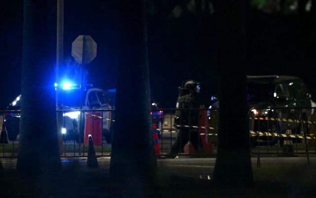 Brazilian police officers inspect the area of a possible bomb in a backpack outside the Supreme Court headquarters in Brasilia on October 1, 2026. Brazilian police are investigating a possible bomb placed in a backpack thrown outside the Supreme Court, the country's highest tribunal reported on October 1, 2026, three days before presidential elections begin. (Photo by Evaristo SA / AFP)