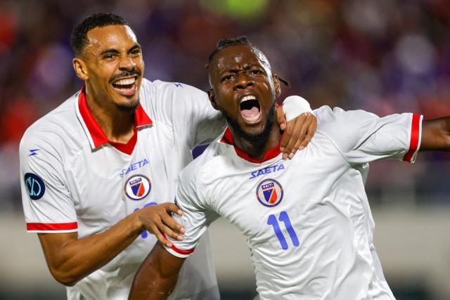 Haiti's forward #11 Louicius Deedson (R) celebrates scoring his team's first goal with teammate forward #18 Wilson Isidor during the Concacaf Nations League Cup football match between Dominican Republic and Haiti at the Felix Sanchez Olympic Stadium in Santo Domingo on October 1, 2026. (Photo by Nelson PULIDO / AFP)