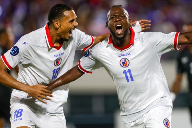 Haiti's forward #11 Louicius Deedson (R) celebrates scoring his team's first goal with teammate forward #18 Wilson Isidor during the Concacaf Nations League Cup football match between Dominican Republic and Haiti at the Felix Sanchez Olympic Stadium in Santo Domingo on October 1, 2026. (Photo by Nelson PULIDO / AFP)