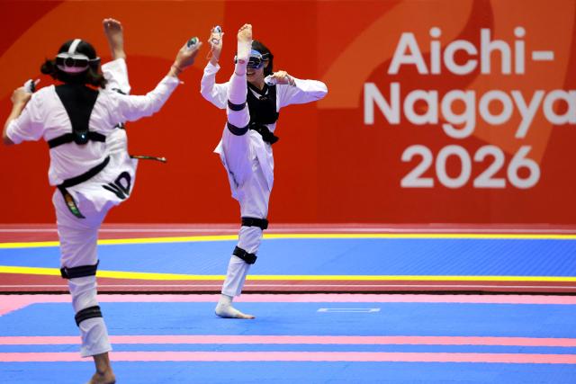 Kazakhstan’s Rita Bakisheva (R) competes against India’s Kashish Malik in the mixed individual virtual taekwondo round 16 during the 2026 Asian Games at the Toyohashi Gymnasium in Toyohashi on October 2, 2026. (Photo by DAVID GRAY / AFP)