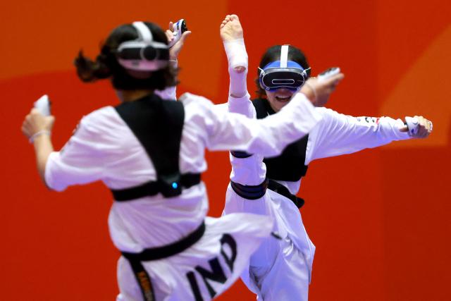 Kazakhstan’s Rita Bakisheva (R) competes against India’s Kashish Malik in the mixed individual virtual taekwondo round 16 during the 2026 Asian Games at the Toyohashi Gymnasium in Toyohashi on October 2, 2026. (Photo by DAVID GRAY / AFP)