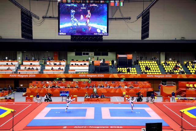 Kazakhstan’s Dunya Saber (R) competes against Jeus Gabriel Derick Yape (L) of the Phillipines in the mixed individual virtual taekwondo competition during the 2026 Asian Games at the Toyohashi Gymnasium in Toyohashi on October 2, 2026. (Photo by DAVID GRAY / AFP)