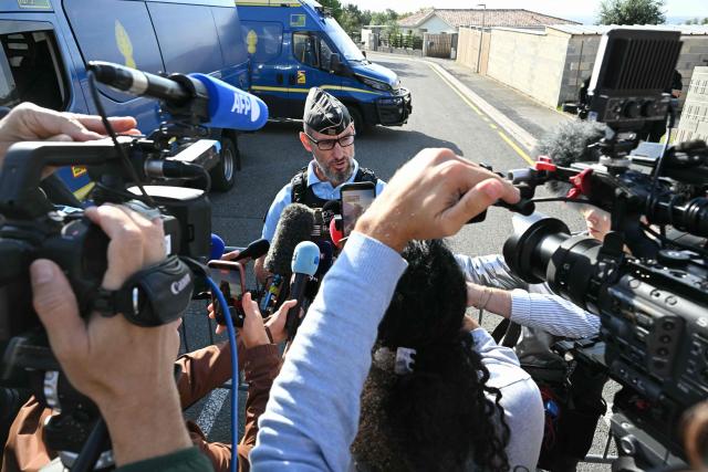 Lieutenant Colonel Stephane Meyblum answers journalists as French gendarmes block the access to a road near the former home of Cedric and Delphine Jubillar in Cagnac-les-Mines, southwestern France, as Cedric Jubillar, who is accused of causing the disappearance of his wife Delphine, takes part in a judicial reconstruction today, on October 2, 2026. (Photo by Lionel BONAVENTURE / AFP)