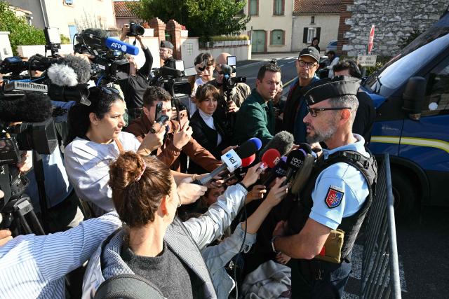 Lieutenant Colonel Stephane Meyblum answers journalists as French gendarmes block the access to a road near the former home of Cedric and Delphine Jubillar in Cagnac-les-Mines, southwestern France, as Cedric Jubillar, who is accused of causing the disappearance of his wife Delphine, takes part in a judicial reconstruction today, on October 2, 2026. (Photo by Lionel BONAVENTURE / AFP)