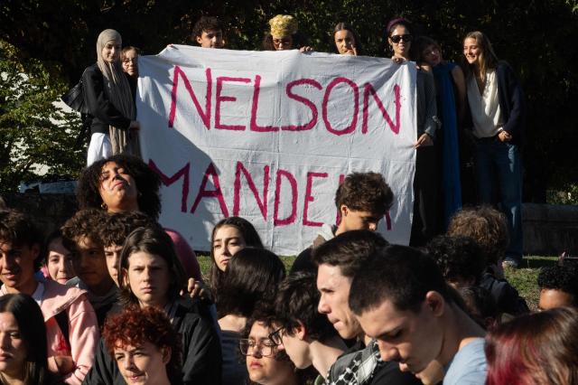 Students of Mandela's high school hold a banner as they gather after a fire destroys the entrance of their school as protesting students carry out blockading action in Nantes, western France, on October 2, 2026. Since late September, students have staged protests outside schools over grievances ranging from timetables, class sizes and a shortage of teachers to overheated classrooms during this year's heatwaves. The protests started in the Ile-de-France region around Paris but have now spread to other cities nationwide. (Photo by Sebastien Salom-Gomis / AFP)