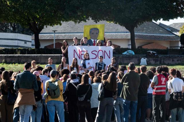 Students of Mandela's high school gather after a fire destroys the entrance of their school as protesting students carry out blockading action in Nantes, western France, on October 2, 2026. Since late September, students have staged protests outside schools over grievances ranging from timetables, class sizes and a shortage of teachers to overheated classrooms during this year's heatwaves. The protests started in the Ile-de-France region around Paris but have now spread to other cities nationwide. (Photo by Sebastien Salom-Gomis / AFP)