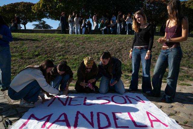 Students of Mandela's high school prepare a banner as they gather after a fire destroys the entrance of their school as protesting students carry out blockading action in Nantes, western France, on October 2, 2026. Since late September, students have staged protests outside schools over grievances ranging from timetables, class sizes and a shortage of teachers to overheated classrooms during this year's heatwaves. The protests started in the Ile-de-France region around Paris but have now spread to other cities nationwide. (Photo by Sebastien Salom-Gomis / AFP)