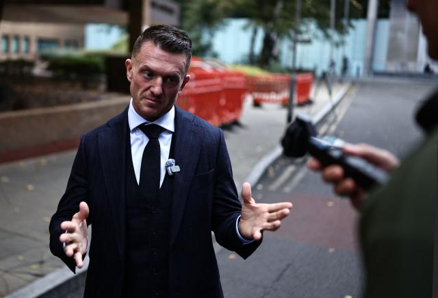British far-right activist Tommy Robinson, real name Stephen Yaxley-Lennon, reacts as he leaves Southwark Crown Court in London on October 2, 2026, after attending a pre-trial hearing. (Photo by Henry NICHOLLS / AFP)