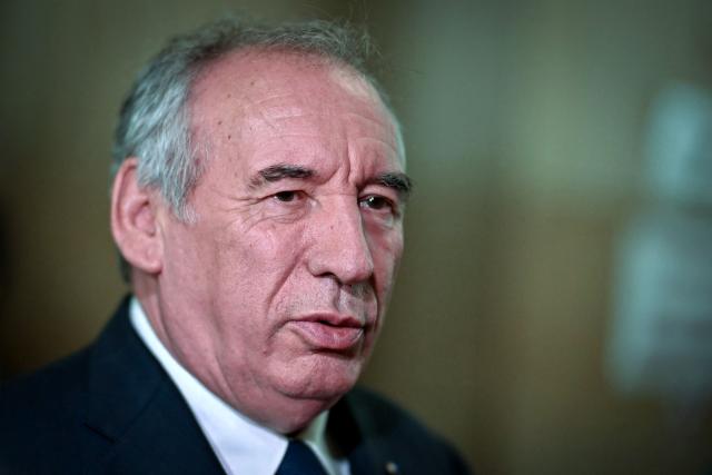 (FILES) French politician and former Prime minister Francois Bayrou speaks to journalists in a break during a hearing of the appeal trial over the alleged misuse of European Parliament funds to pay fictitious parliamentary assistants for the centrist party MoDem, at the Paris' courthouse in Paris on September 9, 2026. Former Prime minister François Bayrou and ten former MoDem executives must answer, starting September 9, 2026, before the Paris appeal court for misappropriation of funds in the case of the MEP assistants, a ten-year-old case in which the former Prime Minister had been acquitted at first instance. (Photo by LOU BENOIST / AFP)