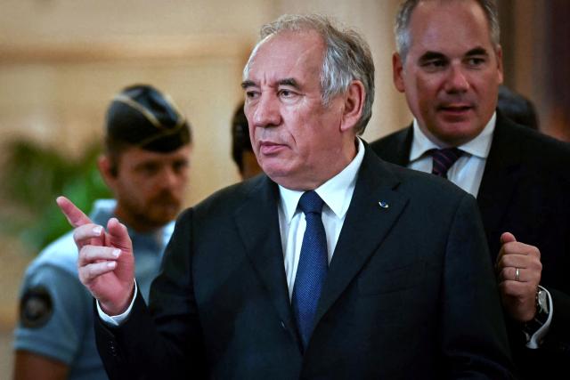 (FILES) French politician Francois Bayrou leaves the courtroom in a break during a hearing of the appeal trial over the alleged misuse of European Parliament funds to pay fictitious parliamentary assistants for the centrist party MoDem, at the Paris' courthouse in Paris on September 9, 2026. Former Prime minister François Bayrou and ten former MoDem executives must answer, starting September 9, 2026, before the Paris appeal court for misappropriation of funds in the case of the MEP assistants, a ten-year-old case in which the former Prime Minister had been acquitted at first instance. (Photo by LOU BENOIST / AFP)