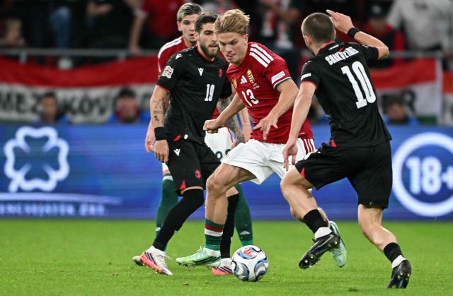 Hungary's midfielder #13 Andras Schafer (C) and Georgia's midfielder #10 Giorgi Chakvetadze (R) vie for the ball during the UEFA Nations League Group B2 football match between Hungary and Georgia at the Puskas Arena in Budapest, Hungary on October 2, 2026. (Photo by Attila KISBENEDEK / AFP)