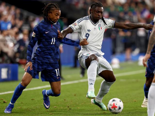 France's midfielder #11 Michael Olise (L) vies with Italy's forward #09 Moise Kean (R) during the UEFA Nations League, league A day 3: Group 1, football match between France and Italy at the Stade de France stadium in Saint-Denis, near Paris, on October 2, 2026. (Photo by FRANCK FIFE / AFP)