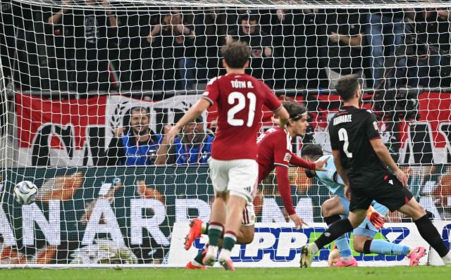 Hungary's midfielder #11 Milos Kerkez (C) scores the opening goal during the UEFA Nations League Group B2 football match between Hungary and Georgia at the Puskas Arena in Budapest, Hungary on October 2, 2026. (Photo by Attila KISBENEDEK / AFP)