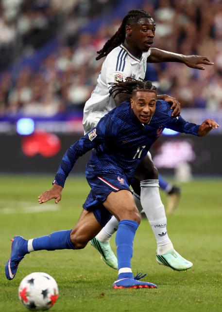 France's midfielder #11 Michael Olise (front) vies with Italy's forward #09 Moise Kean during the UEFA Nations League, league A day 3: Group 1, football match between France and Italy at the Stade de France stadium in Saint-Denis, near Paris, on October 2, 2026. (Photo by FRANCK FIFE / AFP)