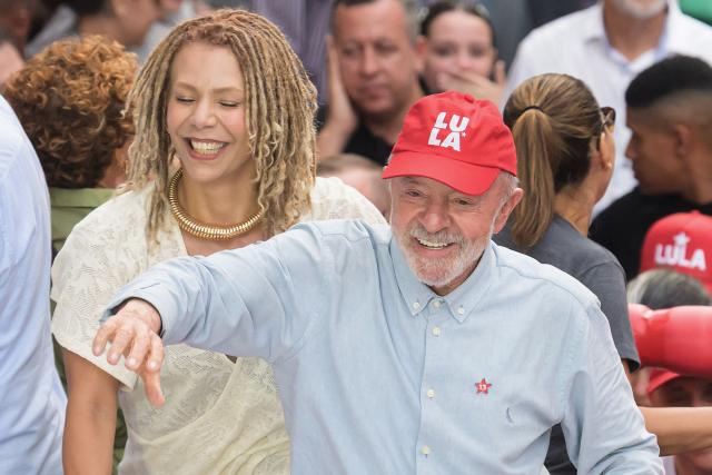 Brazil's President and presidential candidate Luiz Inacio Lula da Silva (R) smiles next to former federal deputy Aurea Carolina (L) during a campaign rally in Belo Horizonte, Minas Gerais state, Brazil on October 2, 2026. Brazilians go to the polls on October 4, 2026, in a tight race led by leftist President Luiz Inacio Lula da Silva and right-wing senator Flavio Bolsonaro, son of former president Jair Bolsonaro. (Photo by Gledston Tavares / AFP)