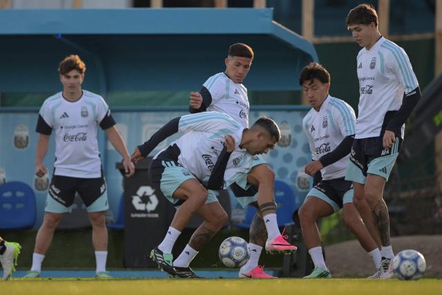 (L to R) Argentina's defender Facundo Medina, midfielder Enzo Fernandez, defender Lisandro Martinez and defender Tomas Palacios fight for the ball during a football training session as forward Julian Alvarez looks on in the background at the Argentine Football Association (AFA) training camp in Ezeiza, Buenos Aires Province, on October 2, 2026, ahead of the friendly matches against Burkina Faso and Benin. (Photo by JUAN MABROMATA / AFP)