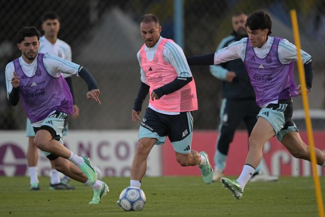 (L to R) Argentina's midfielder Santiago Simon, midfielder Alexis Mac Allister and midfielder Matias Soule fight for the ball during a football training session as forward Julian Alvarez looks on in the background at the Argentine Football Association (AFA) training camp in Ezeiza, Buenos Aires Province, on October 2, 2026, ahead of the friendly matches against Burkina Faso and Benin. (Photo by JUAN MABROMATA / AFP)