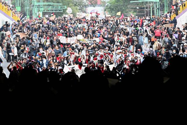 People march during a demonstration marking the 58th anniversary of the 1968 Tlatelolco student massacre in Mexico City on October 2, 2026. (Photo by Alfredo ESTRELLA / AFP)