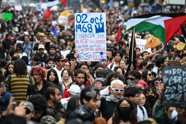 People march during a demonstration marking the 58th anniversary of the 1968 Tlatelolco student massacre in Mexico City on October 2, 2026. (Photo by Yuri CORTEZ / AFP)