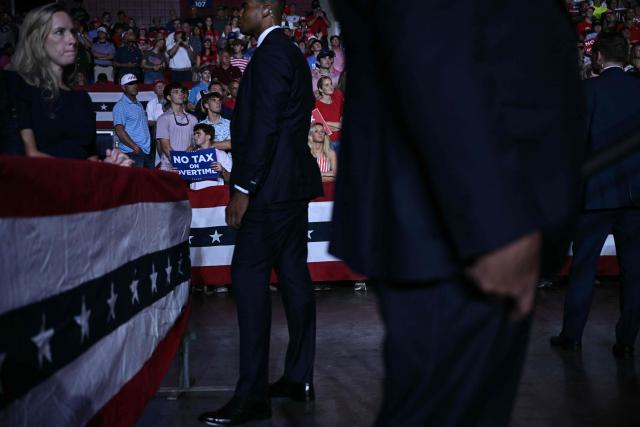US Secret Service Agents scan the crowd as US President Donald Trump speaks during a midterm campaign rally at The Mitchell Center of the University of South Alabama in Mobile, Alabama on October 2, 2026. (Photo by Brendan SMIALOWSKI / AFP)