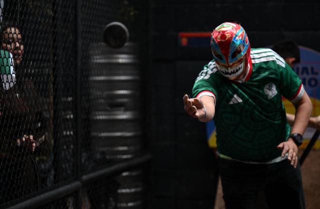 A member of the Mexican delegation throws a tejo during the fourth edition of the Tejo World Championship, a traditional Colombian sport, in Bogota on October 2, 2026. Tejo is Colombia's national sport, in which players throw a heavy metal disc at a clay-filled target, aiming to hit small gunpowder-filled packets that explode on impact. (Photo by Raul ARBOLEDA / AFP)