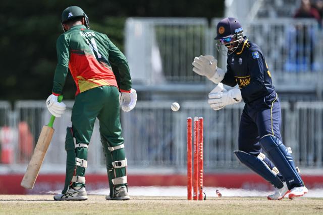 Bangladesh's Al Islam Aliss (L) is stumped by Sri Lanka in their cricket match for bronze during the 2026 Asian Games at the Korogi Athletic Park in Nisshin on October 3, 2026. (Photo by ANDREW CABALLERO-REYNOLDS / AFP)