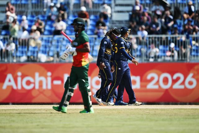 Sri Lankan players (R) celebrate their win against Bangladesh in their cricket match for bronze during the 2026 Asian Games at the Korogi Athletic Park in Nisshin on October 3, 2026. (Photo by ANDREW CABALLERO-REYNOLDS / AFP)