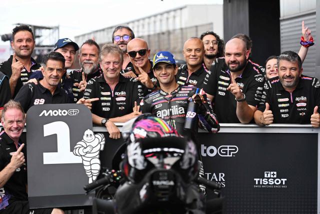Aprilia Racing rider Jorge Martin of Spain (C) celebrates his pole position with his team officers at the Parc Ferme during the MotoGP class qualifying of MotoGP Japanese Grand Prix at the Mobility Resort Motegi in Motegi, Tochigi prefecture on October 3, 2026. (Photo by Toshifumi KITAMURA / AFP)