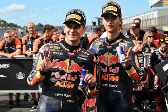 Second placed Red Bull KTM Ajo rider Brian Uriarte of Spain (R) and third placed Red Bull KTM Ajo rider Alvaro Carpe of Spain (L) pose for a photo at the Parc Ferme of the Moto3 class qualifying session of MotoGP Japanese Grand Prix at the Mobility Resort Motegi in Motegi, Tochigi prefecture on October 3, 2026. (Photo by Toshifumi KITAMURA / AFP)