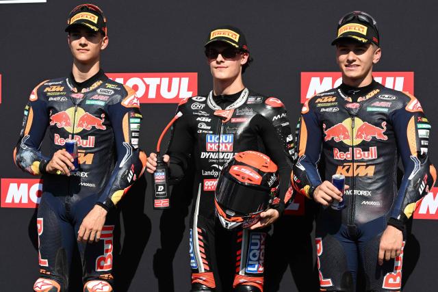 Pole sitter Liqui Moly Dynavolt Intract GP rider David Almansa of Spain (C), second placed Red Bull KTM Ajo rider Brian Uriarte of Spain (L) and third placed Red Bull KTM Ajo rider Alvaro Carpe of Spain (R) pose at the Parc Ferme of the Moto3 class qualifying session of MotoGP Japanese Grand Prix at the Mobility Resort Motegi in Motegi, Tochigi prefecture on October 3, 2026. (Photo by Toshifumi KITAMURA / AFP)